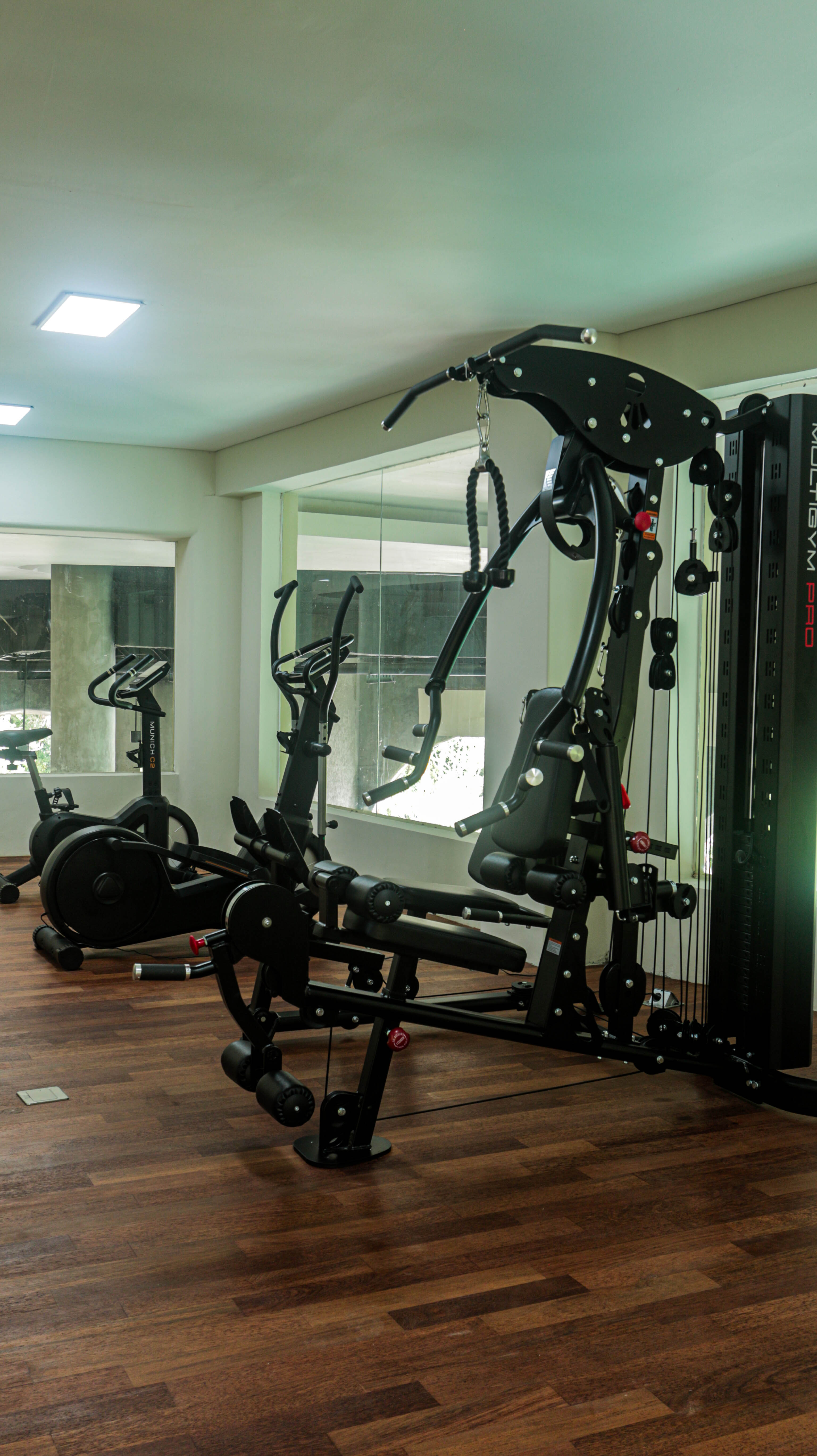 Modern gym at Sanggraloka Ubud fitness center with tropical resort view wellness training and healthy lifestyle Bali luxury hotel